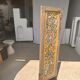 Rectangular Indonesian construction element with blue and yellow plant in carved wood