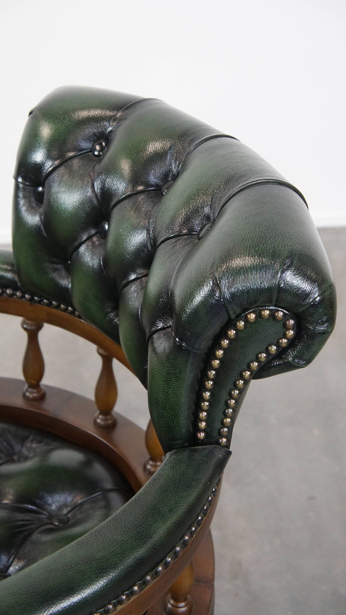 Dark green cowhide leather and wood chesterfield office chair on wheels