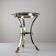 Neoclassical side table in brass and bevelled glass with ram's heads, 1970s.