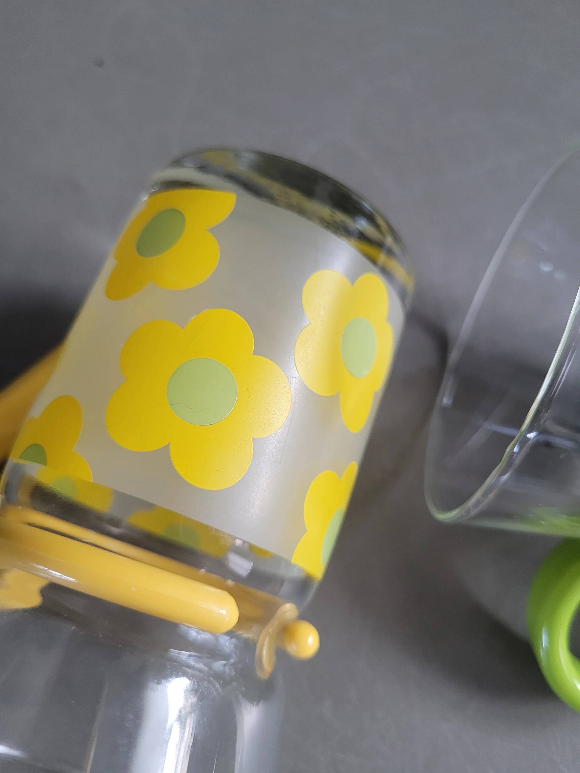 Pair of glass teacups with plastic handles