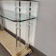 Hollywood Regency console style in travertine, glass, and Lucite.