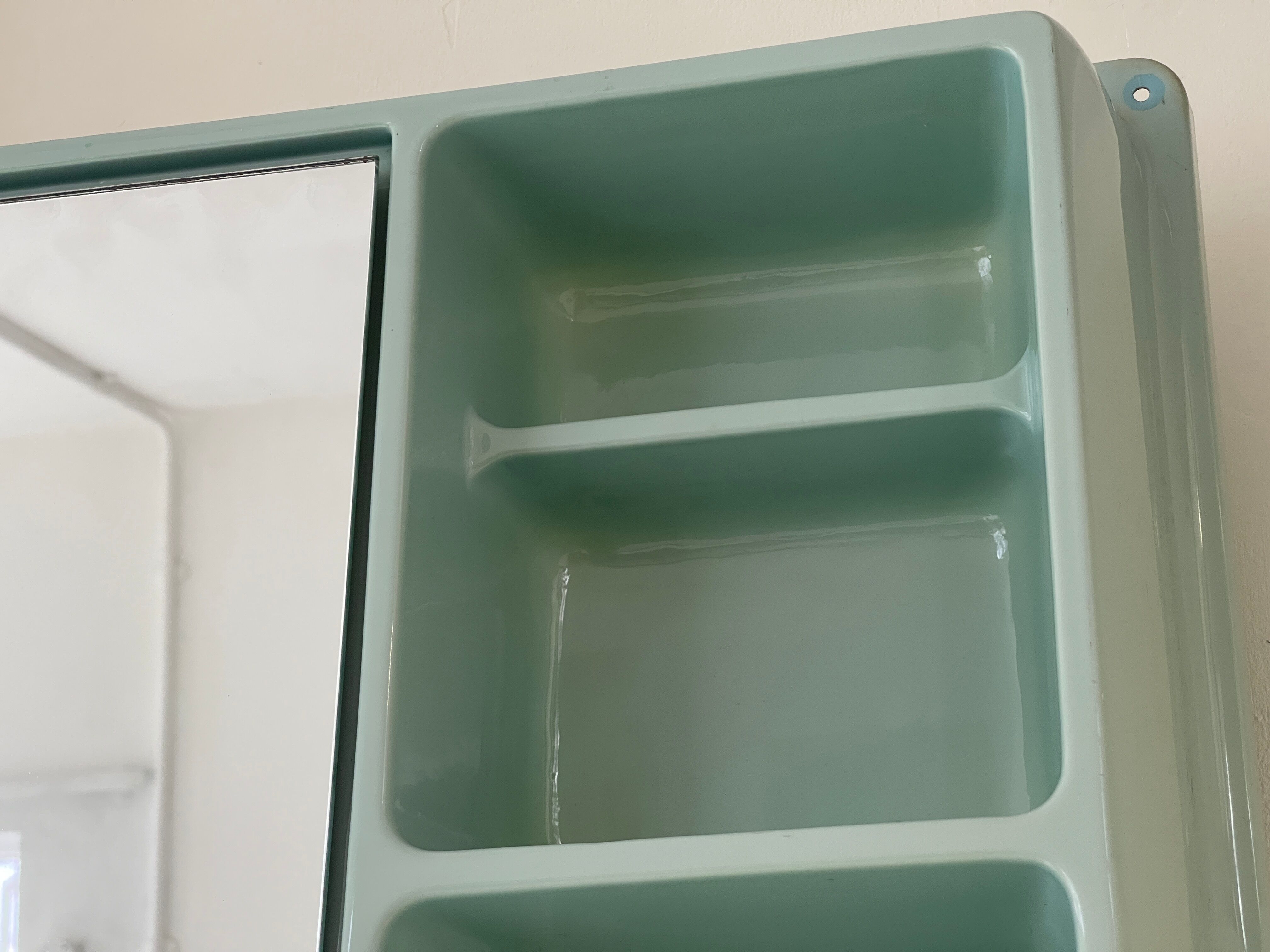 Baby blue plastic mirror and wash station