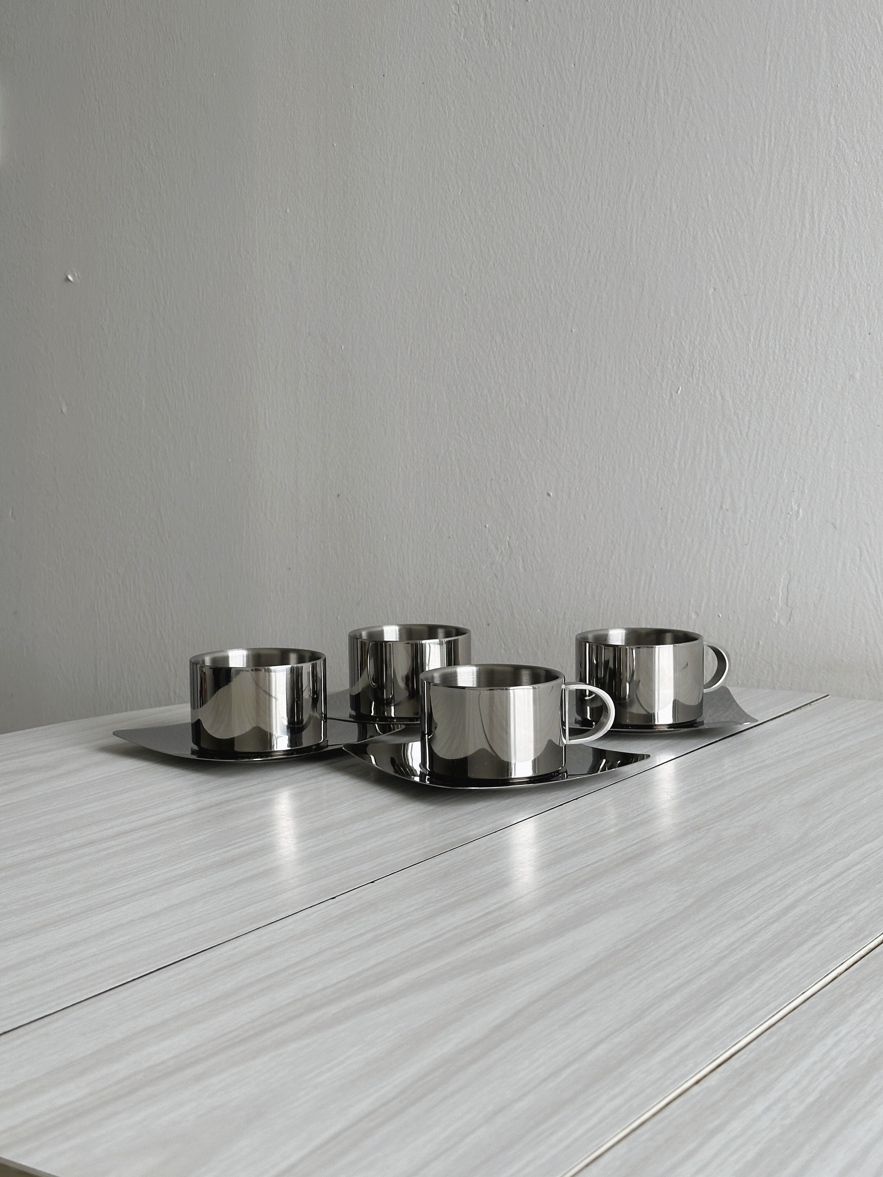 set of 4 stackable stainless steel coffee cups with saucers
