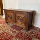 Small antique oak chest with carved panels.