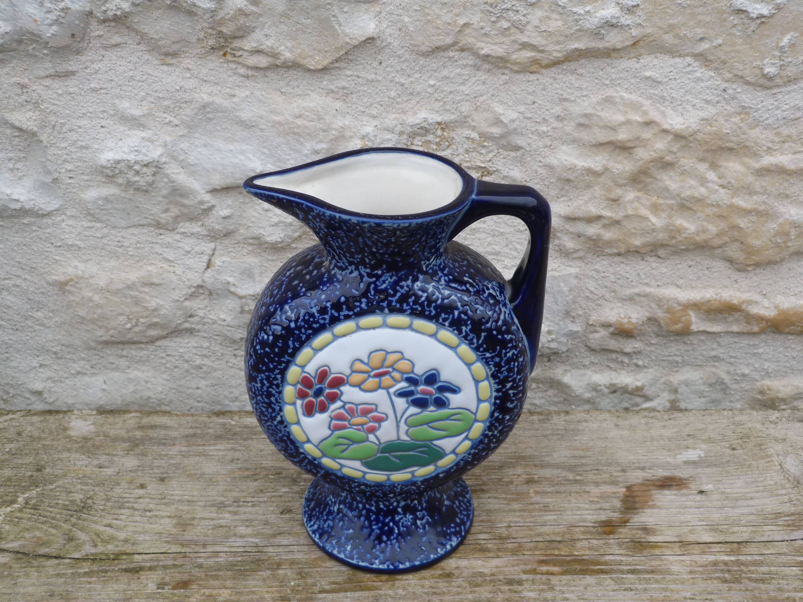 Blue ceramic vase with floral motifs