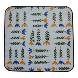 Vintage laminated wooden trivet with yellow, green, and blue flowers
