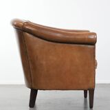 Characterful club chair made of sheepskin leather with light cognac colours