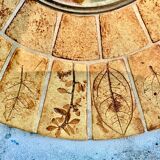 Round ceramic mirror decorated with leaves, signed Roger Capron, 50