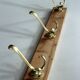 Wall mounted wooden coat rack with 3 brass hooks, vintage from the 50s