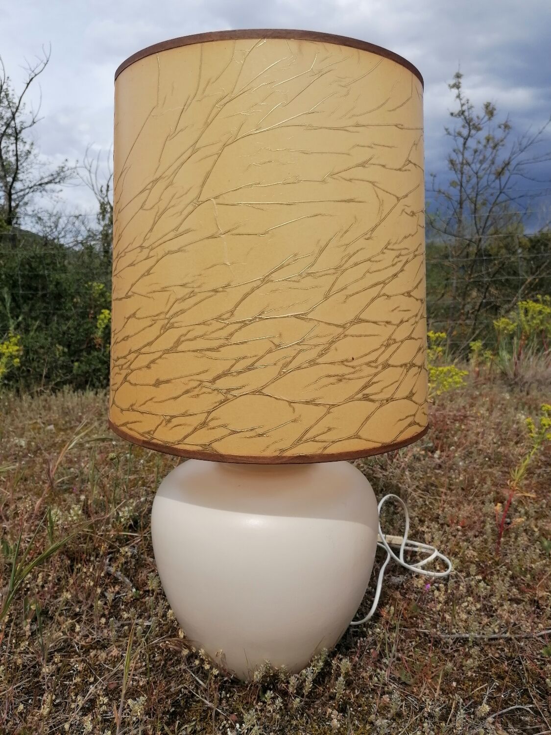 Vintage ceramic table lamp and golden lampshade.