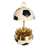 Vintage cigarette dispenser in the shape of a football.