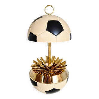 Vintage cigarette dispenser in the shape of a football.