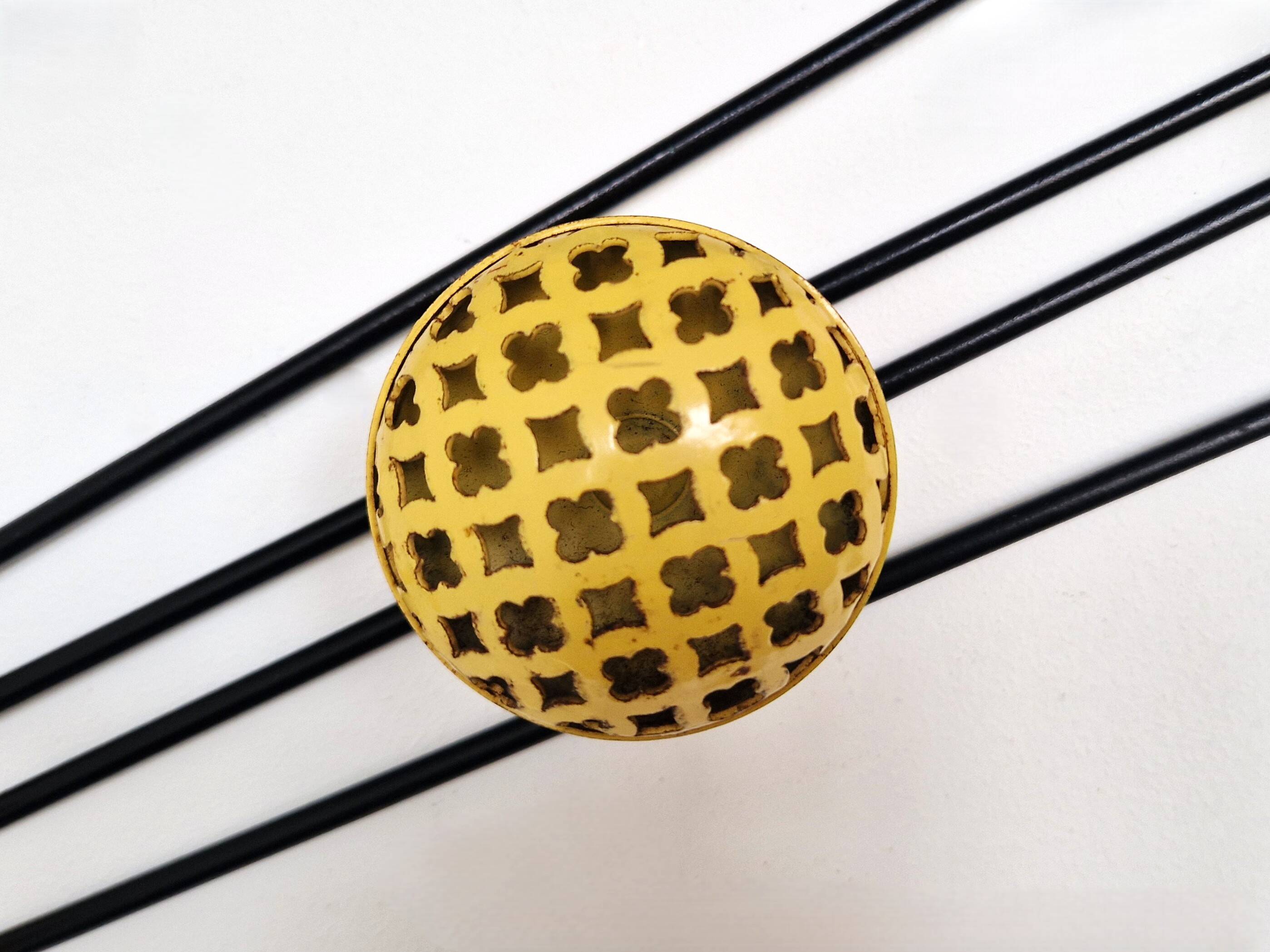 Black and yellow wall coat rack, France