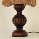 Mid-century French table lamp made of turned carved wood with a fringed shade.