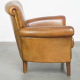 Beautiful and comfortable sheepskin armchair, finished with decorative nailheads
