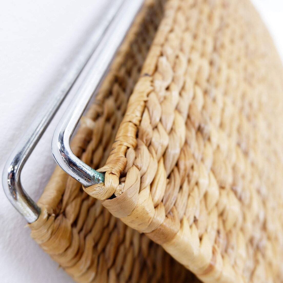 Chrome metal magazine rack with woven banana leaves