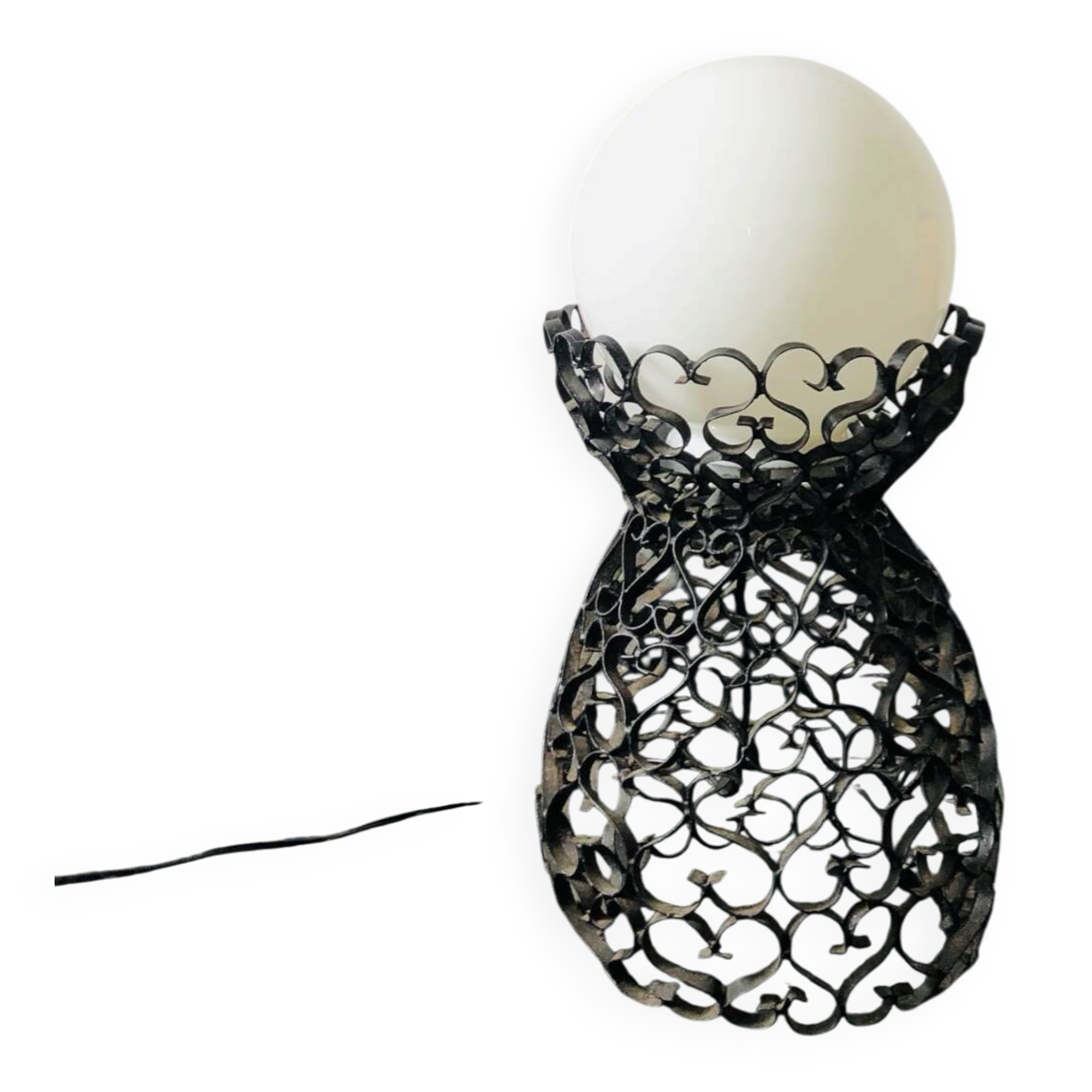 Handcrafted wrought iron lamp with a white opaline globe.
