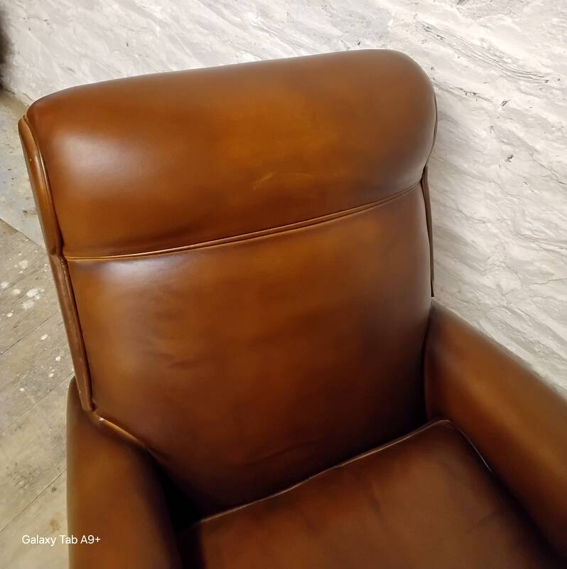 Antique club armchair from the 1950s with compass feet