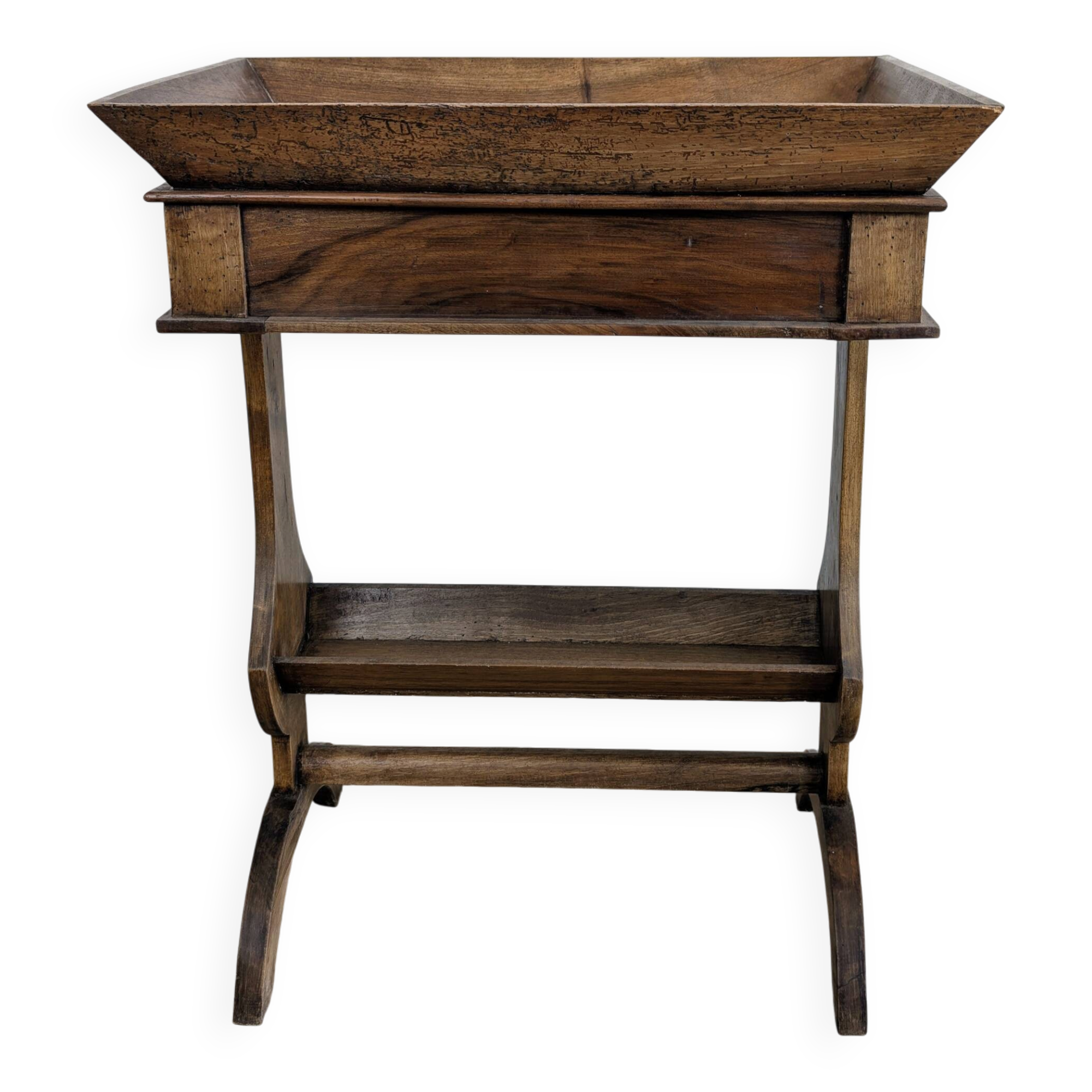 Old wooden pocket emptying table with drawer and planter.