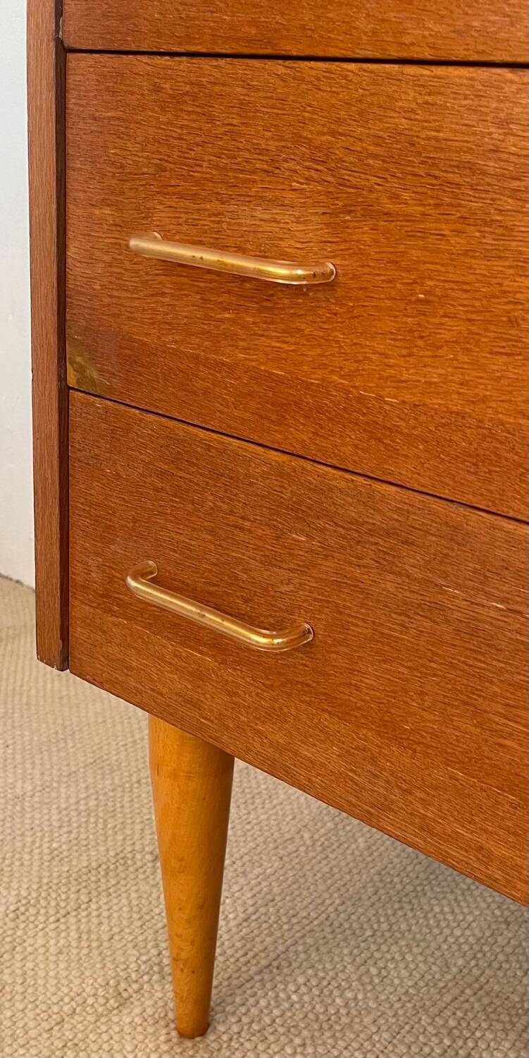 Vintage 1960s chest of drawers with covered handles.