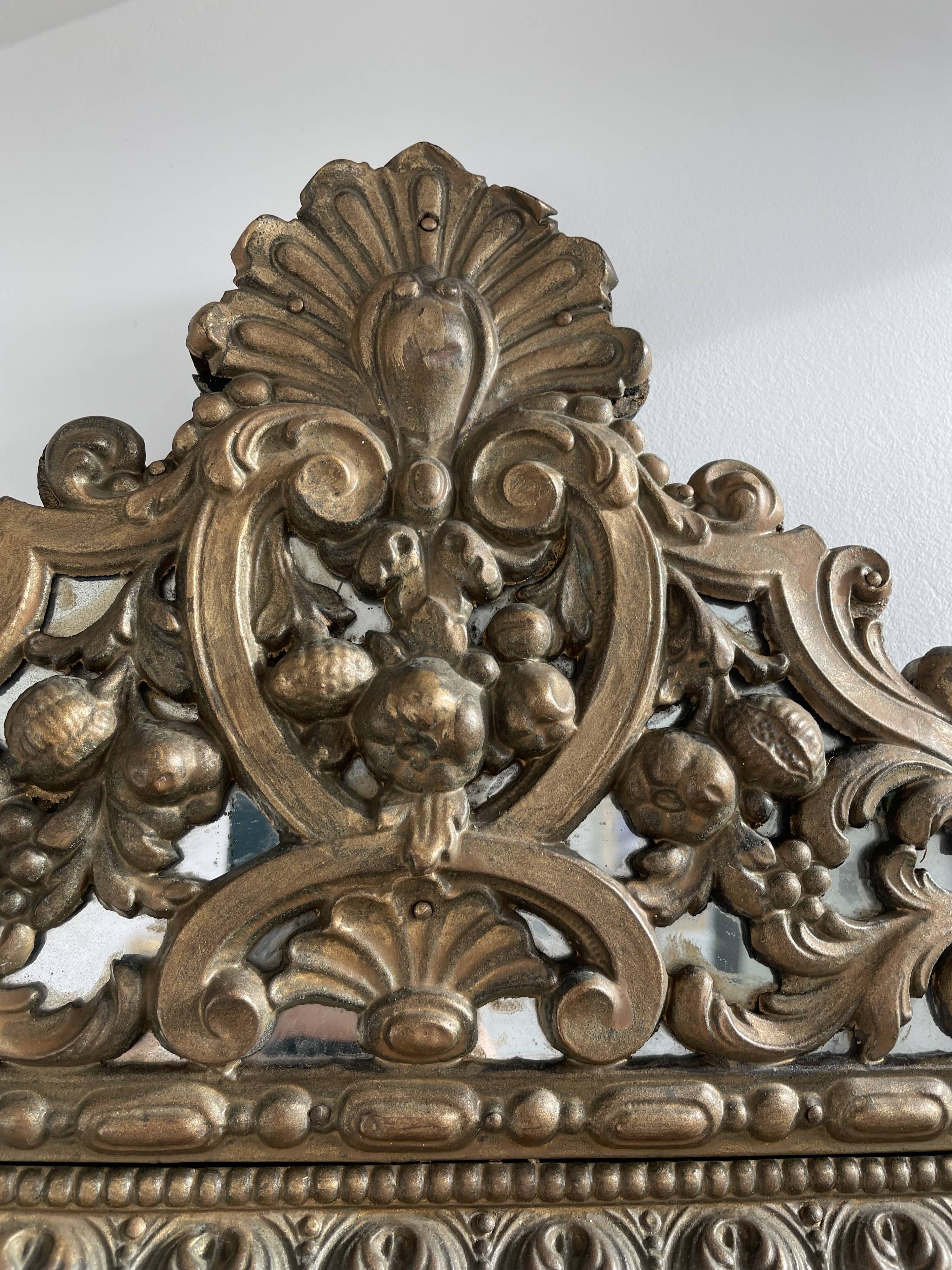 Small mirror with brass parcloses in repoussé style Louis XIV, late 19th century.
