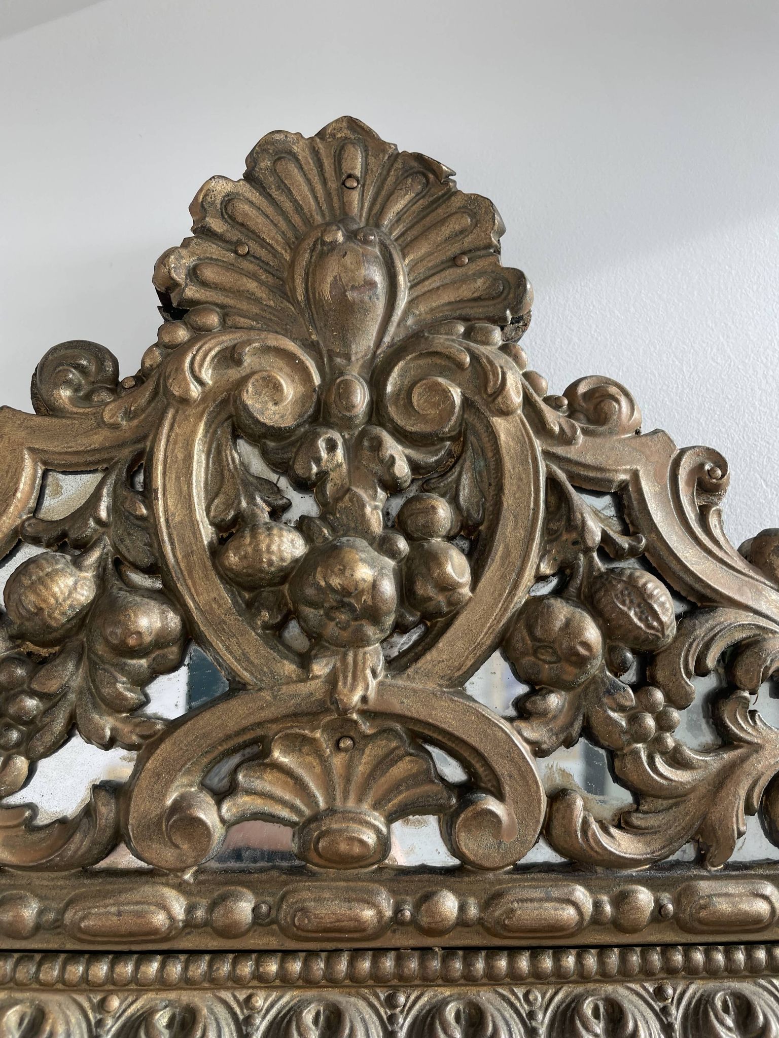 Small mirror with brass parcloses in repoussé style Louis XIV, late 19th century.