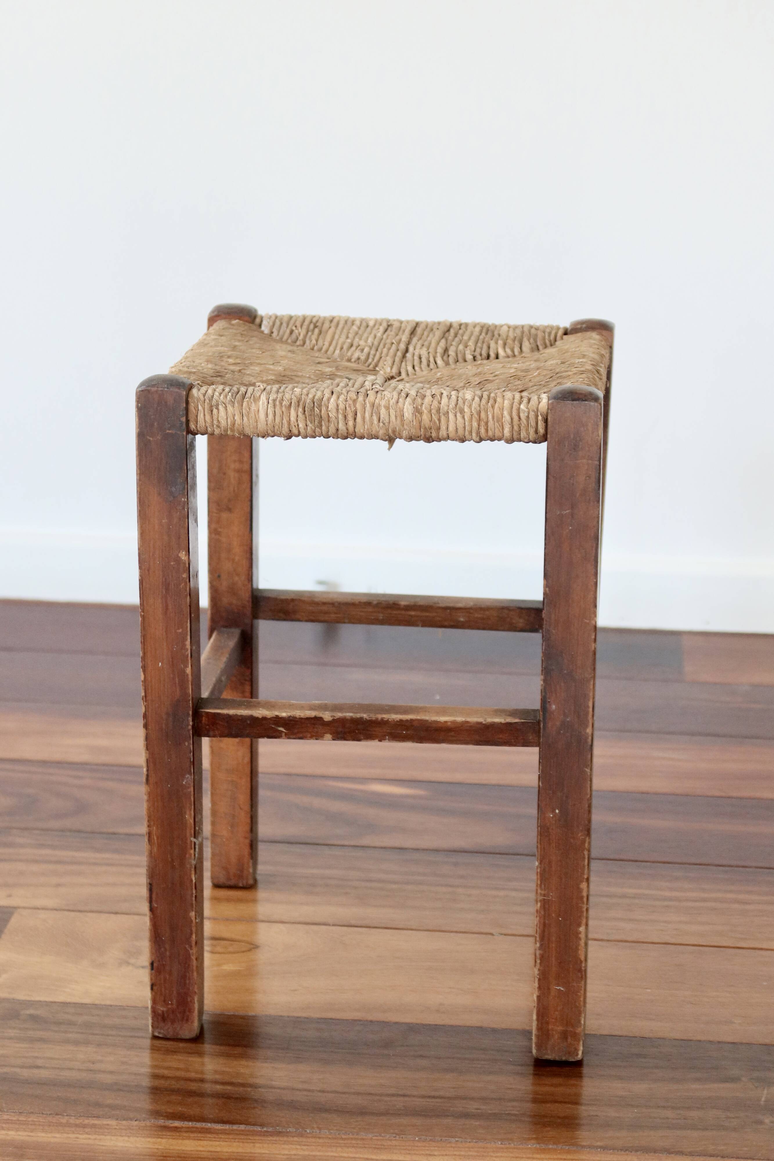 Rustic old stool made of wood and straw.