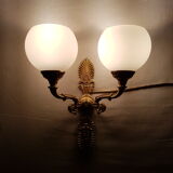 Wall light in gilded bronze and opaque glass globe