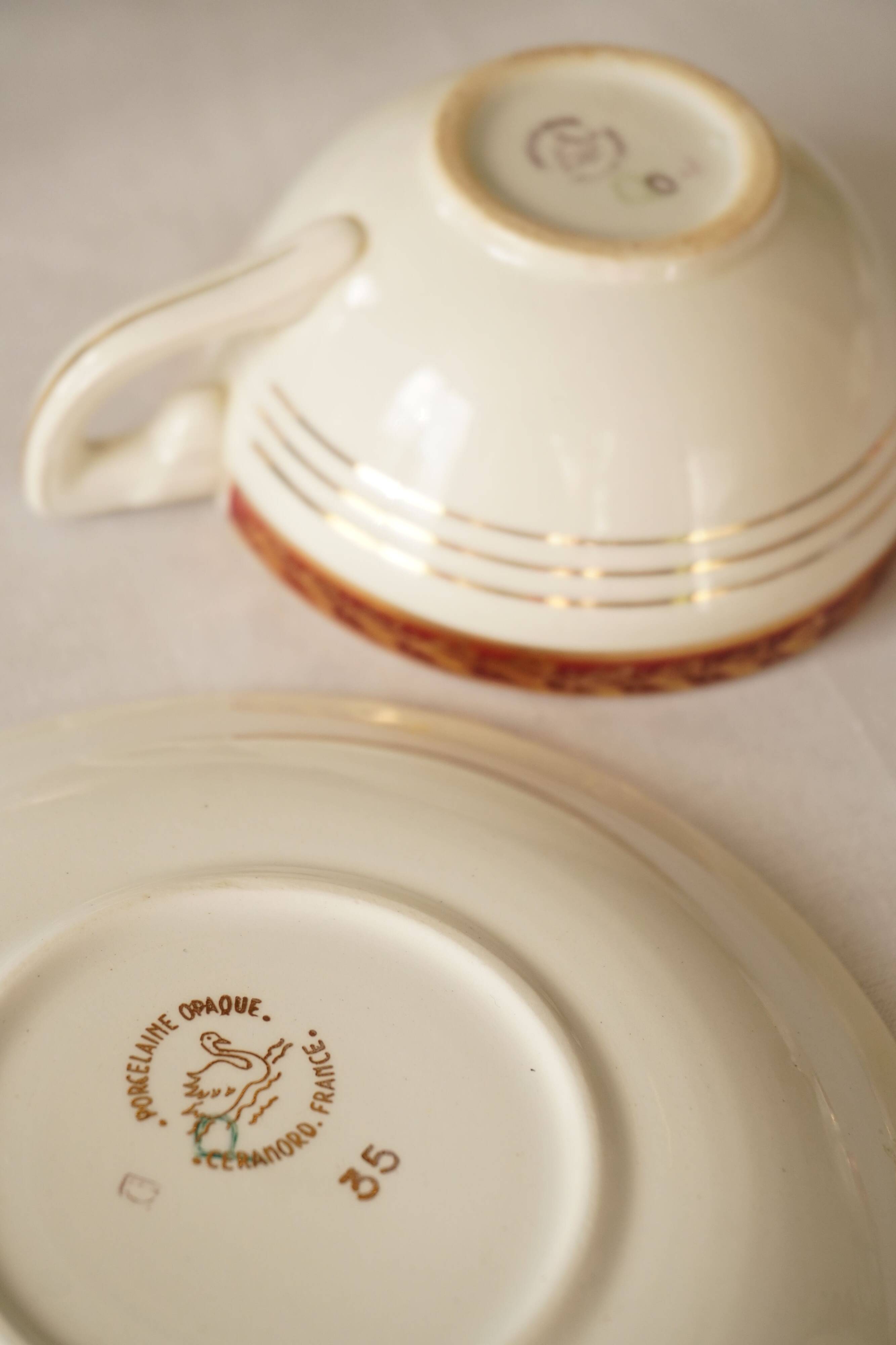 Set of 4 white, red and gold porcelain teacups, Ceranord