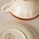 Set of 4 white, red and gold porcelain teacups, Ceranord