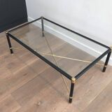 Brass coffee table upholstered in black leather. In the style of Jacques Adnet.