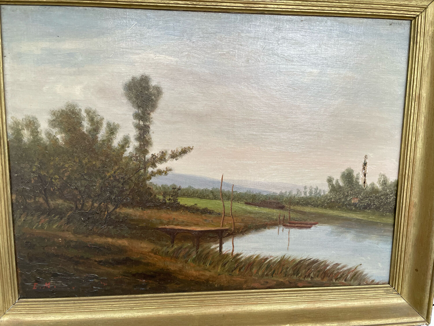 Oil painting of a riverside signed EM