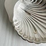 Old metal plate in the shape of a shell.