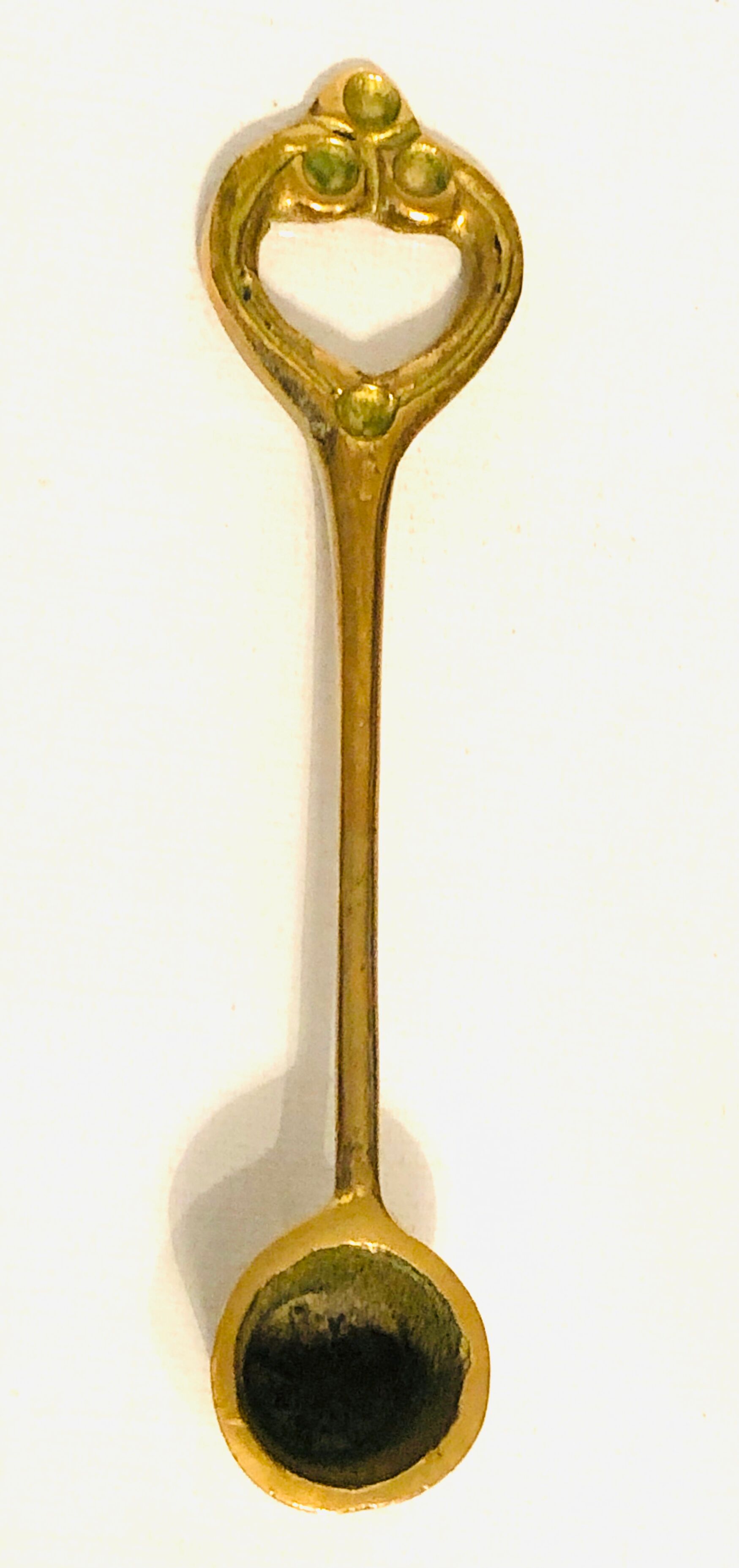 Antique candle extinguisher in golden brass