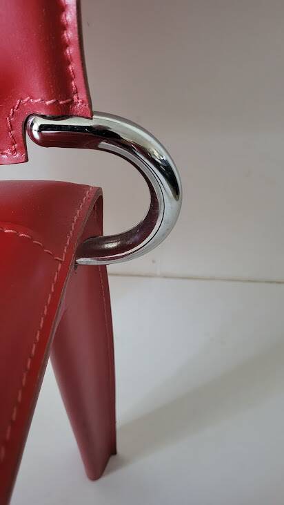 Red leather dining chairs by Arper