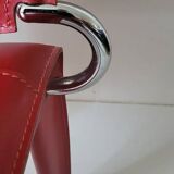 Red leather dining chairs by Arper