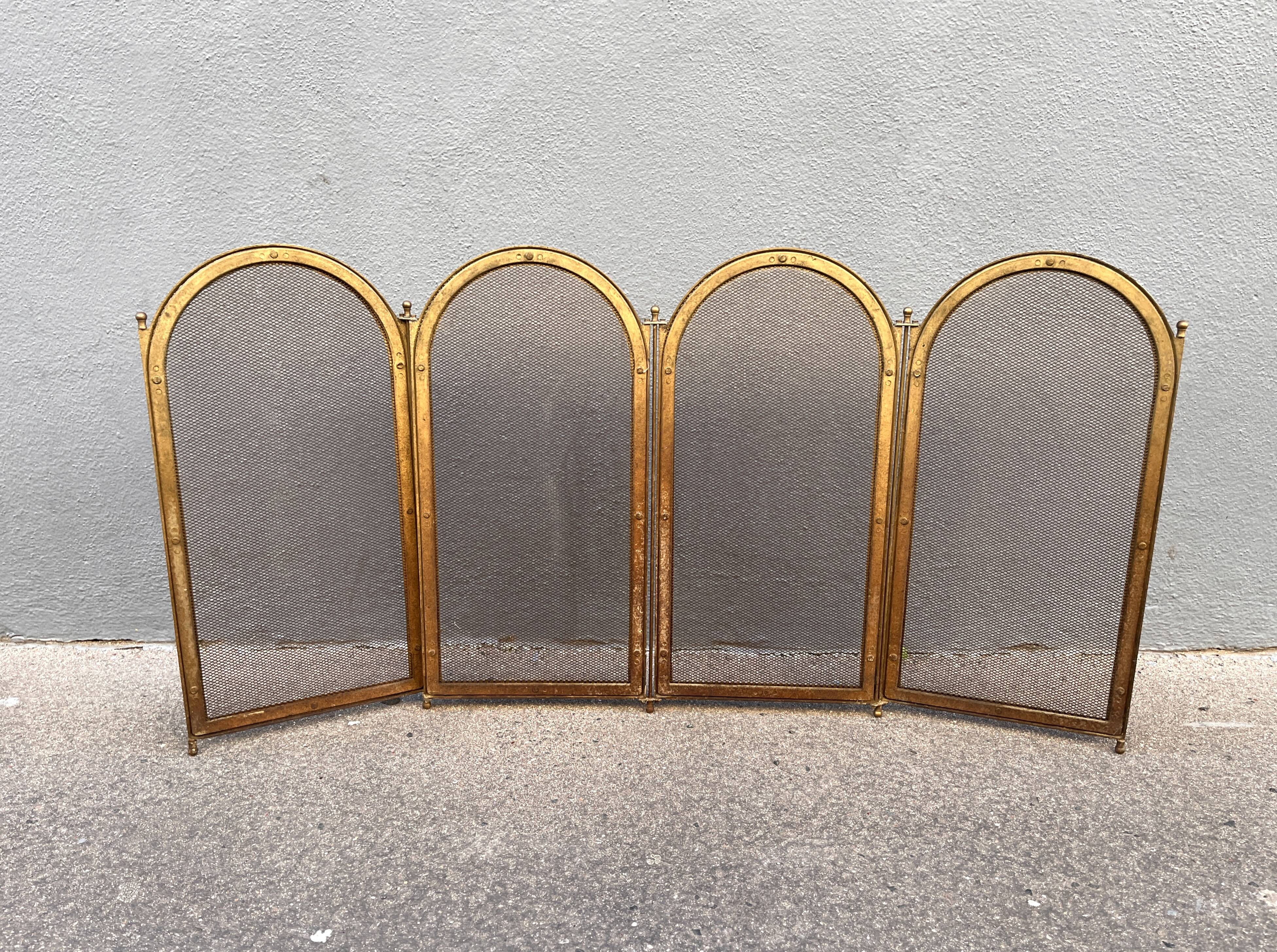 Antique brass fireplace screen from 1920, vintage spark guard.
