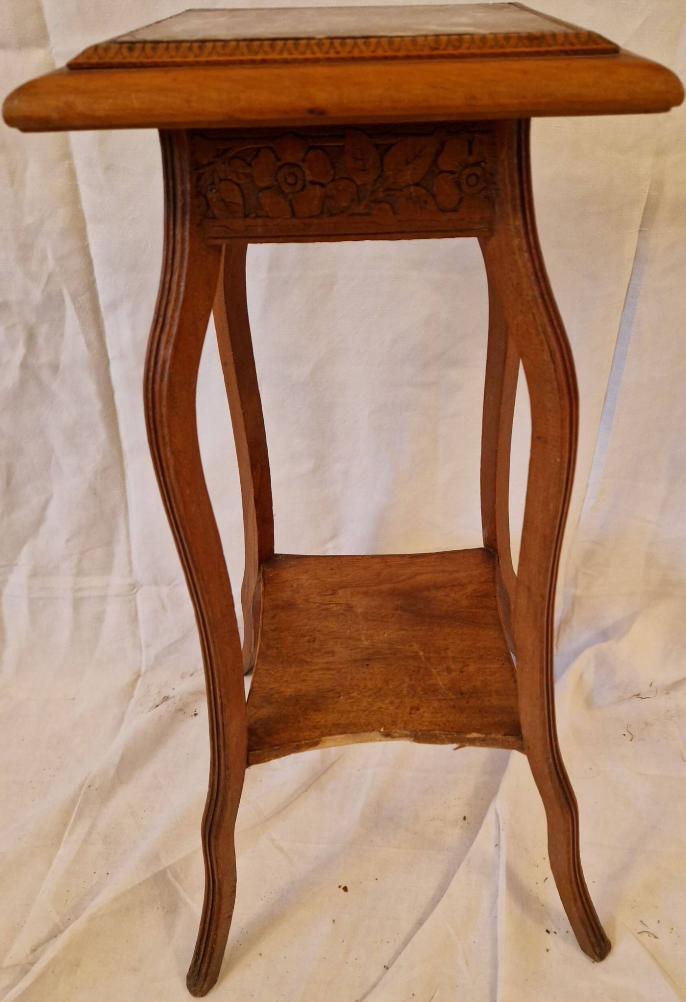 Antique Art Nouveau pedestal table with carved wood and marble top.
