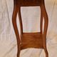 Antique Art Nouveau pedestal table with carved wood and marble top.