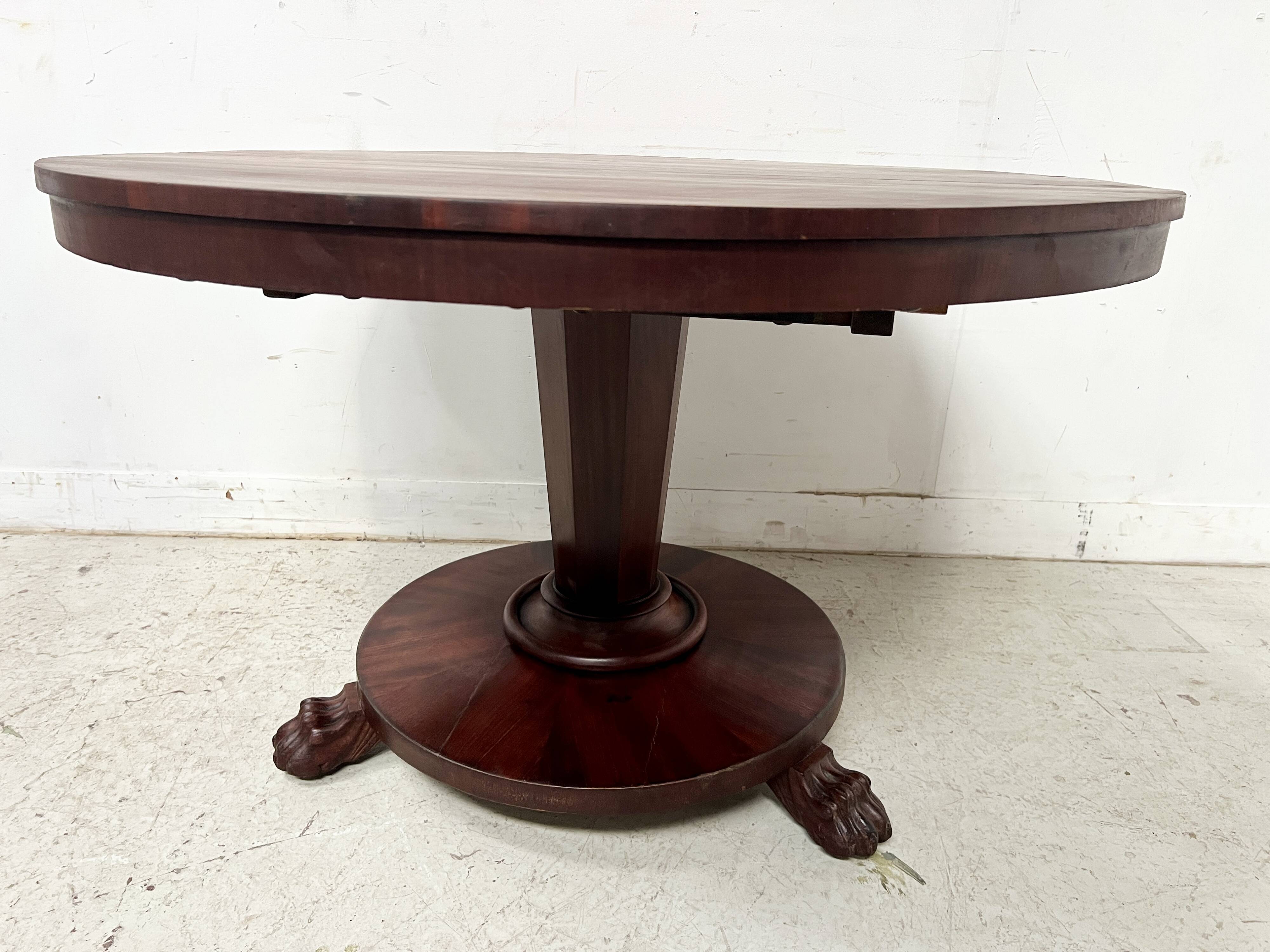 Empire style round table with claw feet, 19th century.