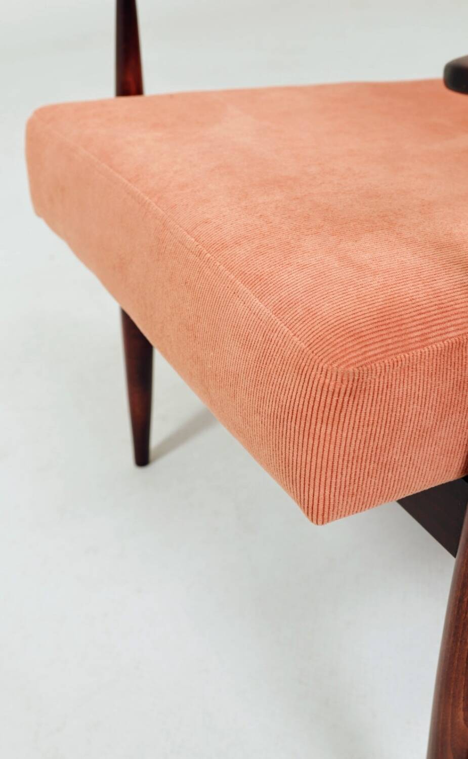 Mid-century modern armchair in coral red designed by H. Lis.