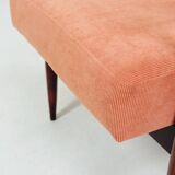 Mid-century modern armchair in coral red designed by H. Lis.