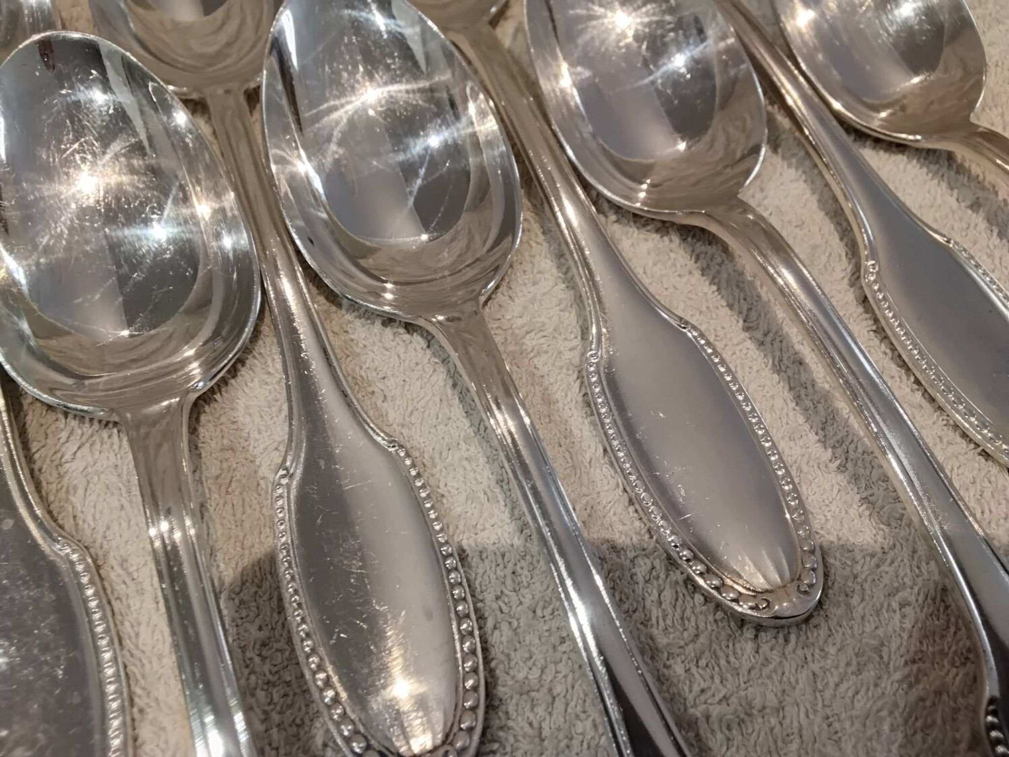 12 silver plated dessert spoons, goldsmith Alfenide, St LXVI pearls