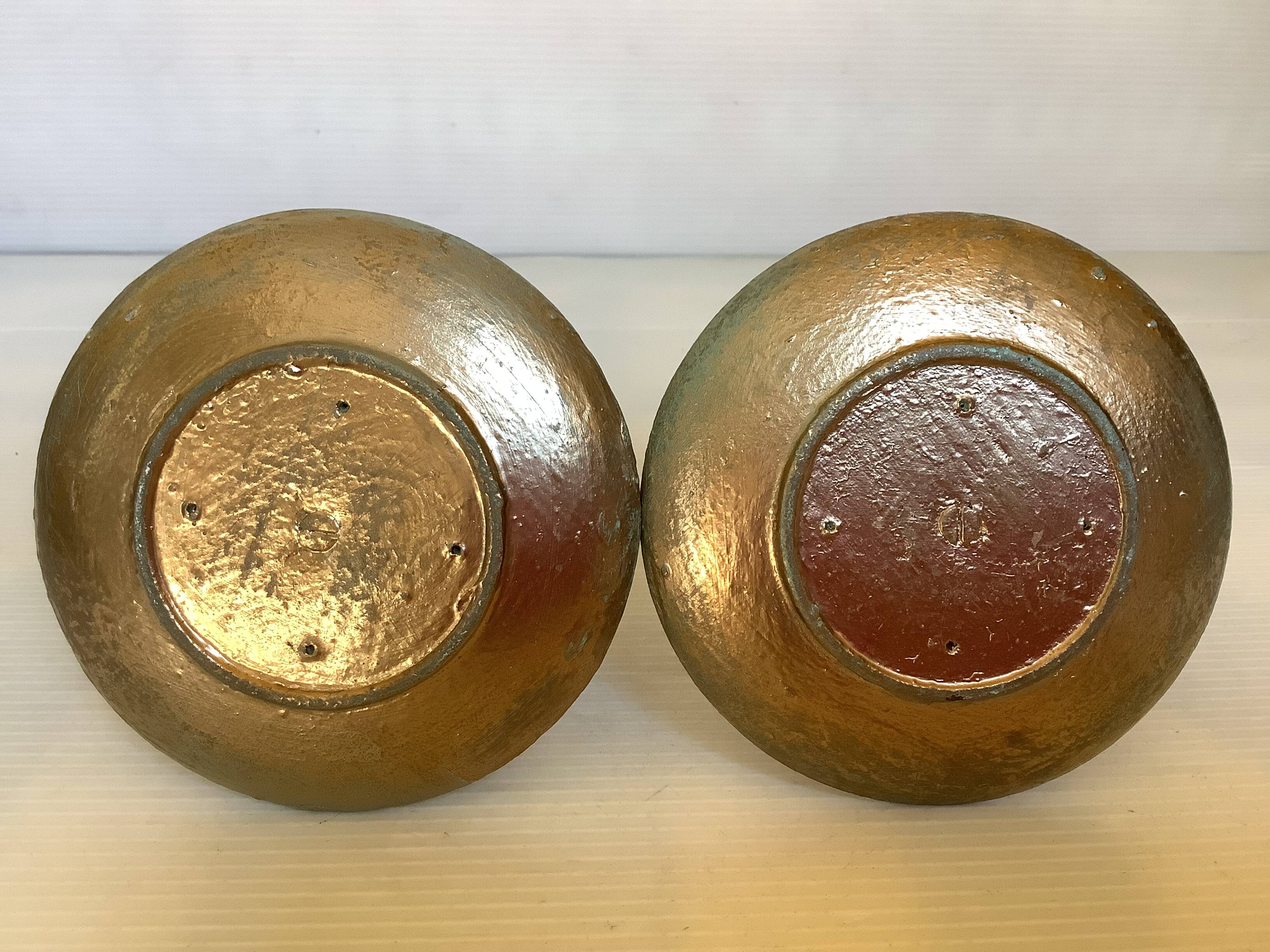 Pair of green and gold wooden candlesticks