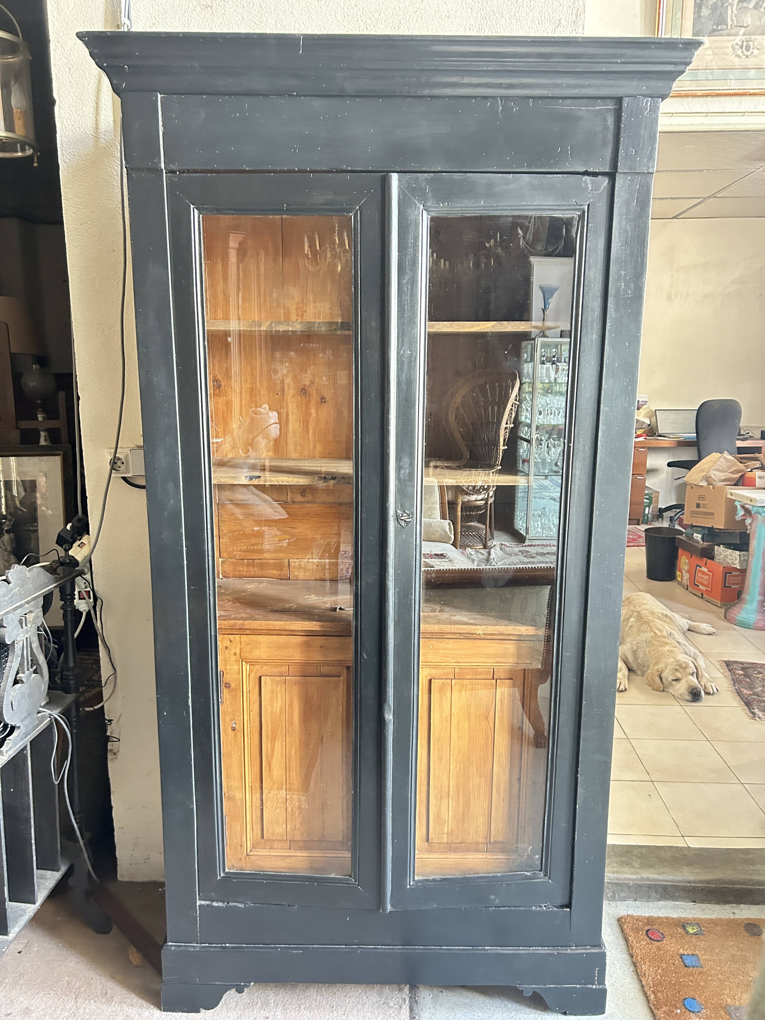 Black painted wardrobe with two glass doors and an interior sideboard.