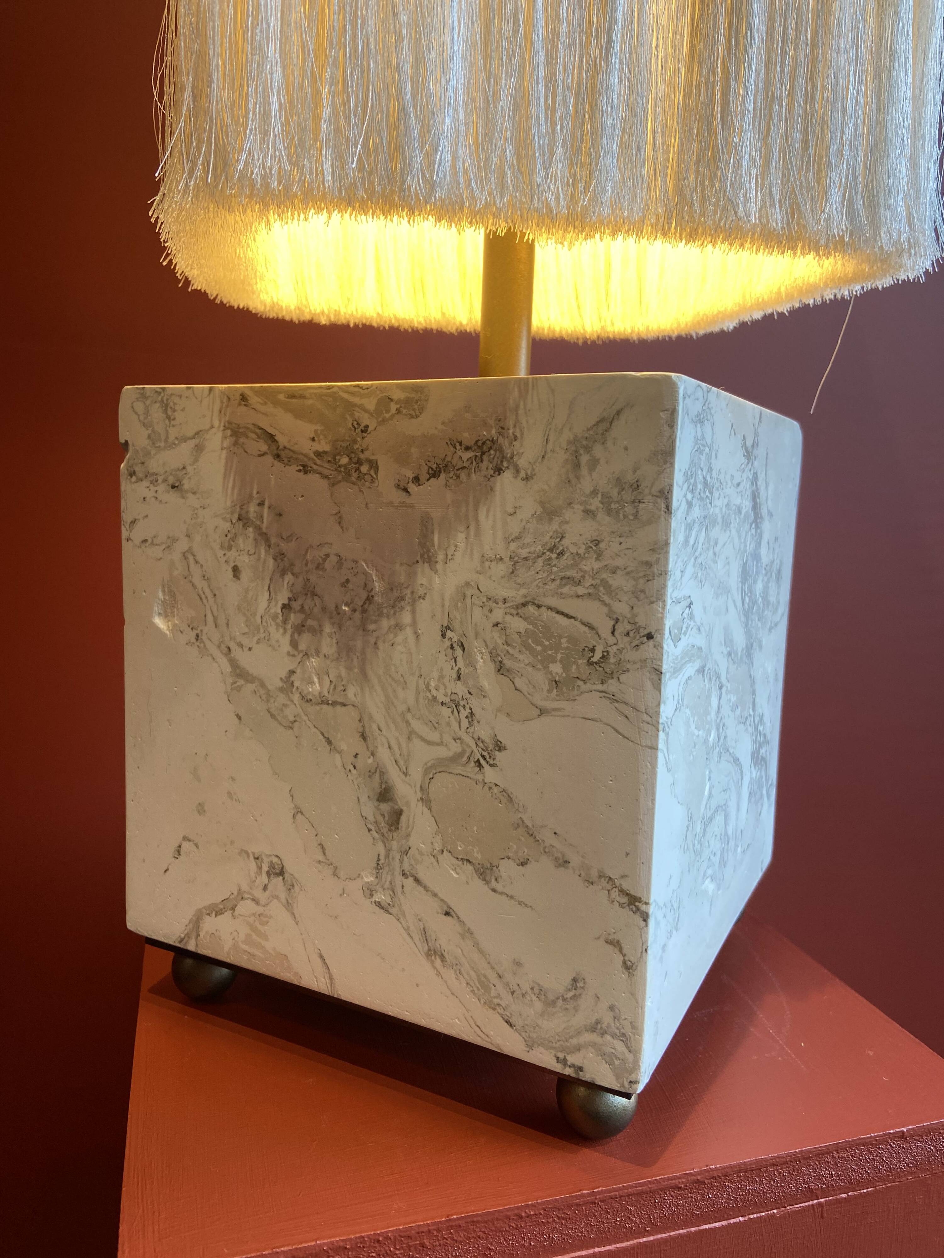 Beige marble stucco base, Houles white ecru fringed lampshade.