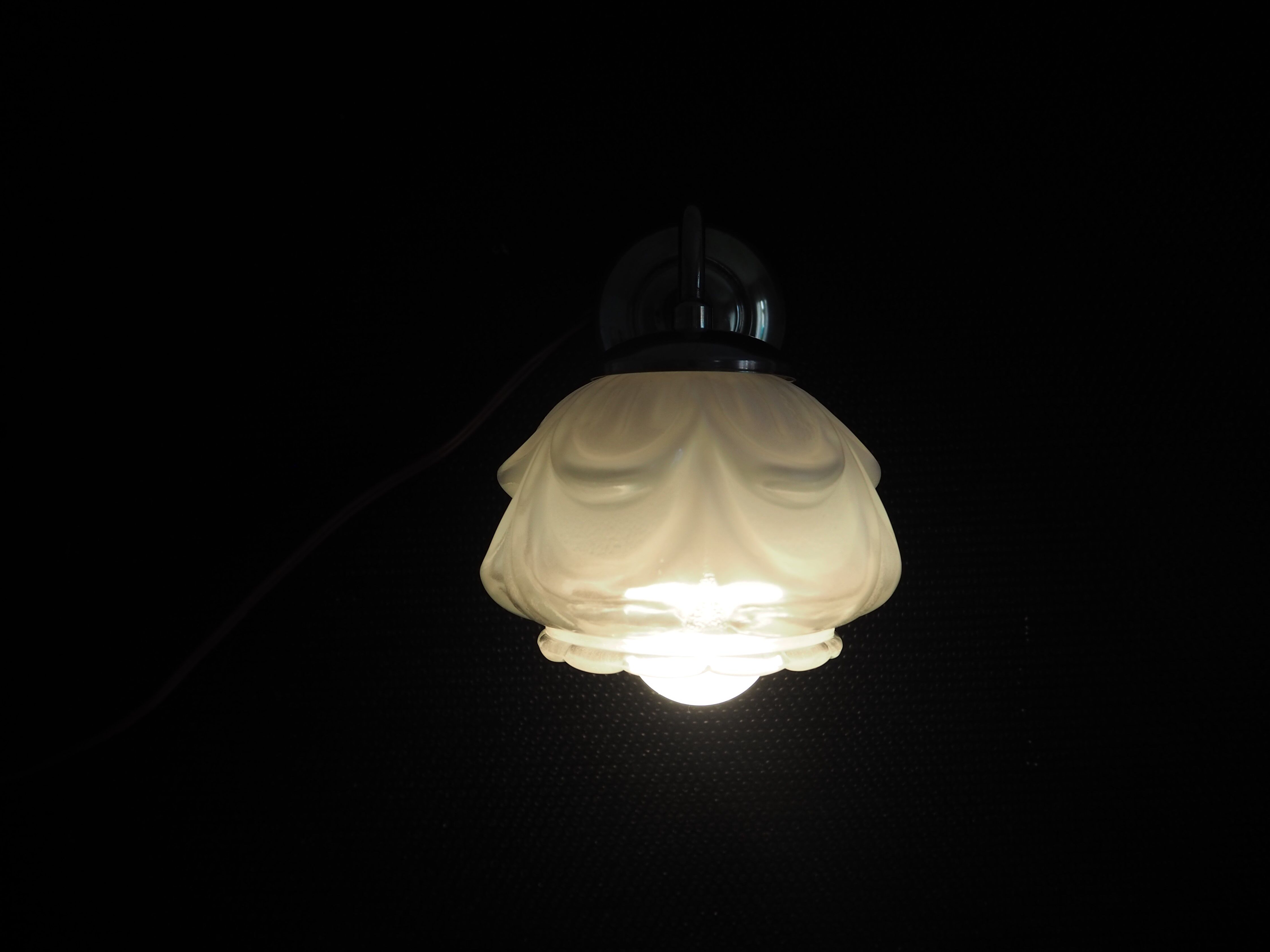Brass wall lamp and white glass globe from the 1950s-1960s.