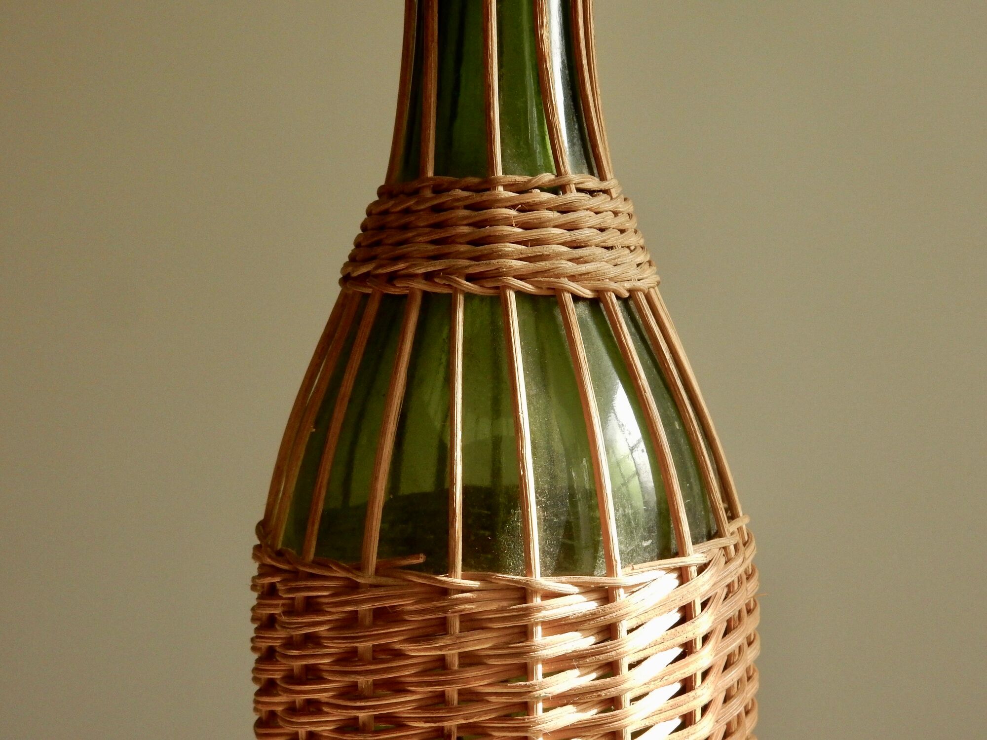 Glass bottle covered with wicker, France of the 60