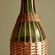 Glass bottle covered with wicker, France of the 60