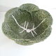 Vintage salad bowl in dabbling cabbage leaf and cutlery